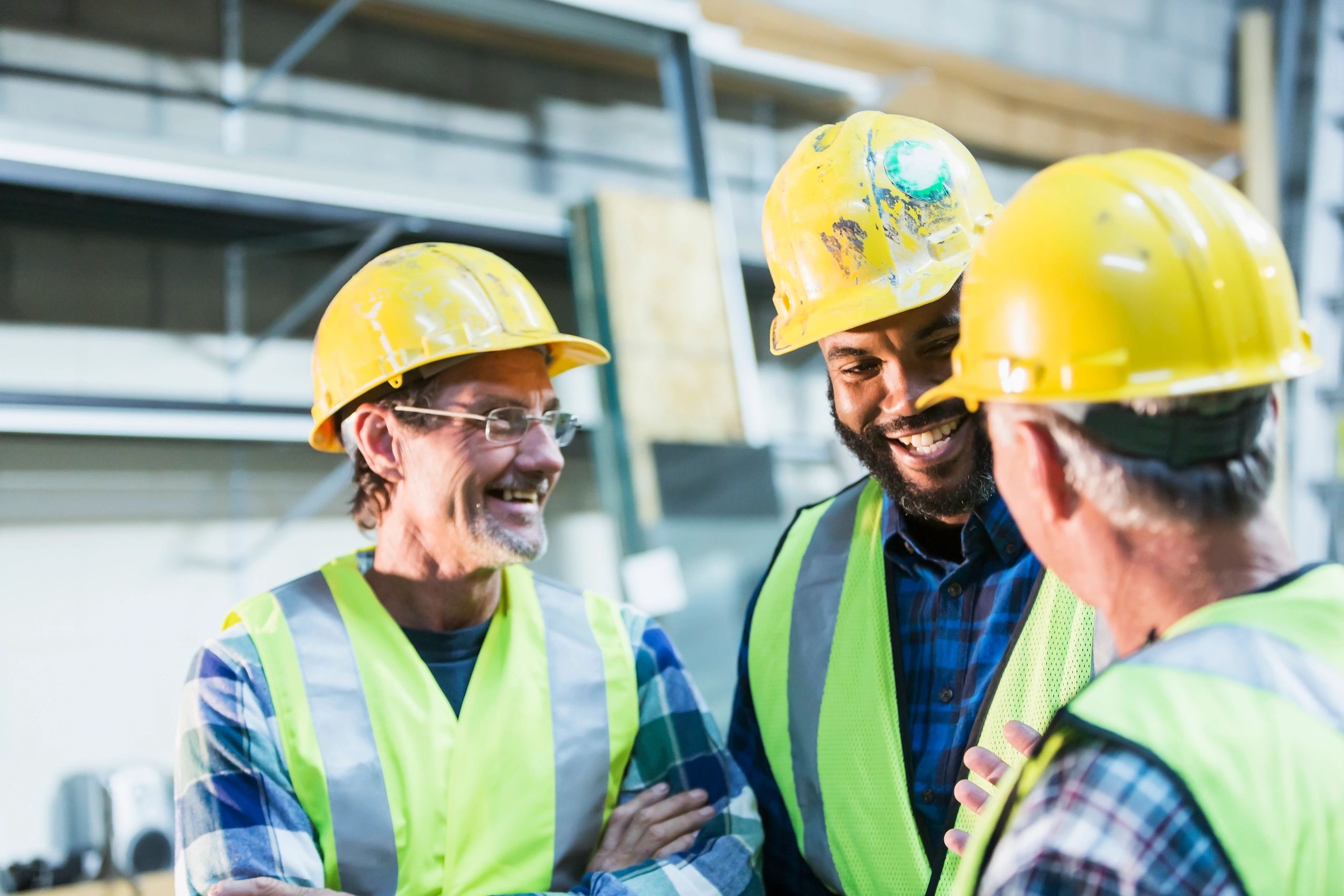 Manufacturing team meeting with safety gear